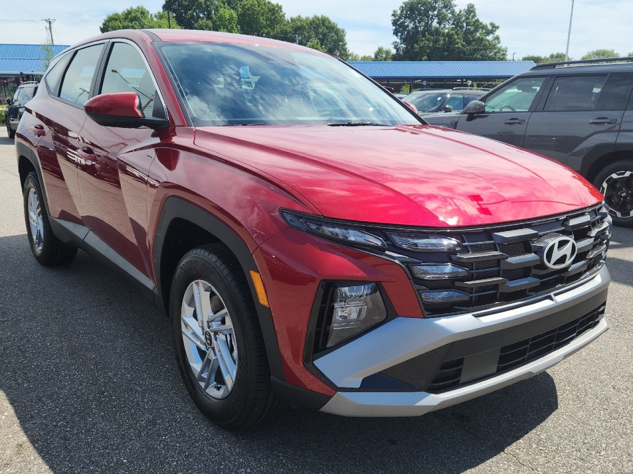 2026 Hyundai TUCSON SE AWD in Red — front three-quarter view